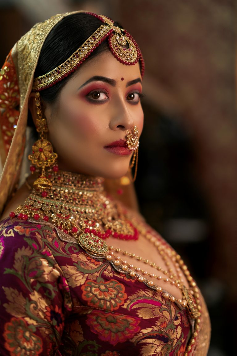 Portrait of an Indian bride showcasing intricate jewelry and traditional bridal attire.