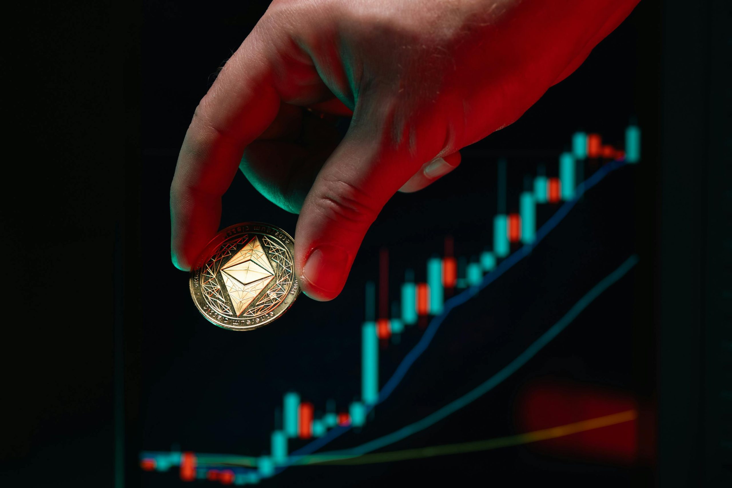 A hand holding an Ethereum coin against a rising stock market graph, symbolizing cryptocurrency growth.